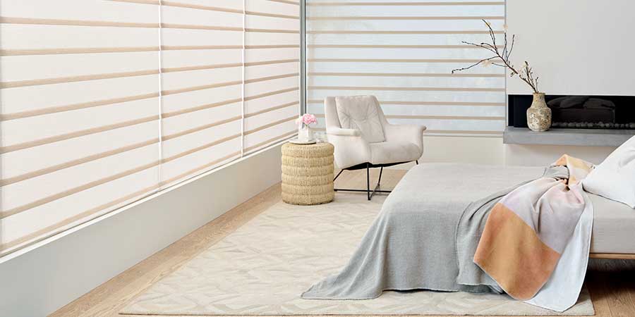 A white bedroom with rolling roman shades on the windows. Halifax