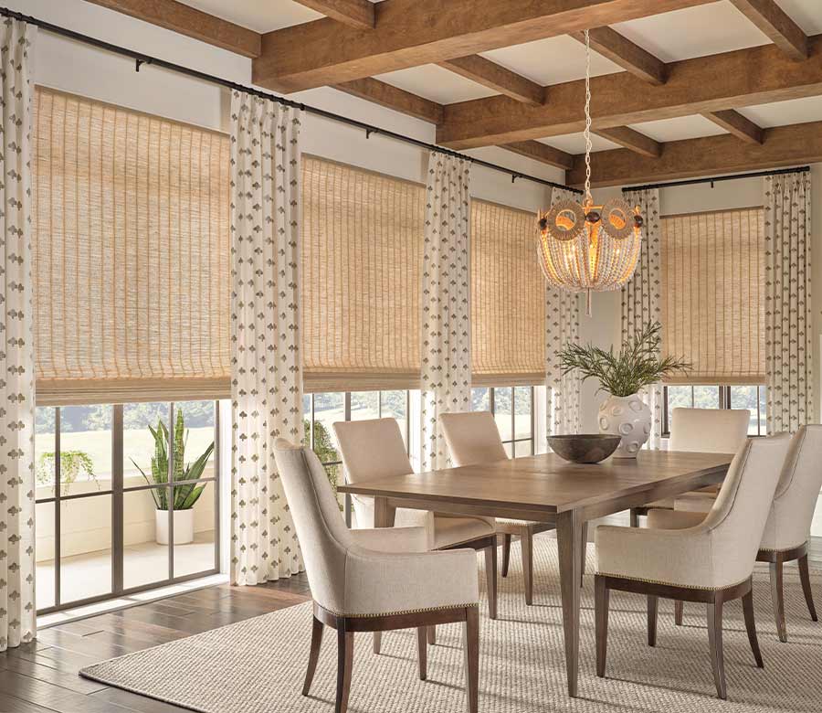 woven wood shades paired with drapery for layering on dining room windows