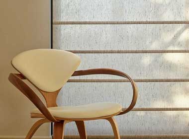 roller shades in a light brown with chair