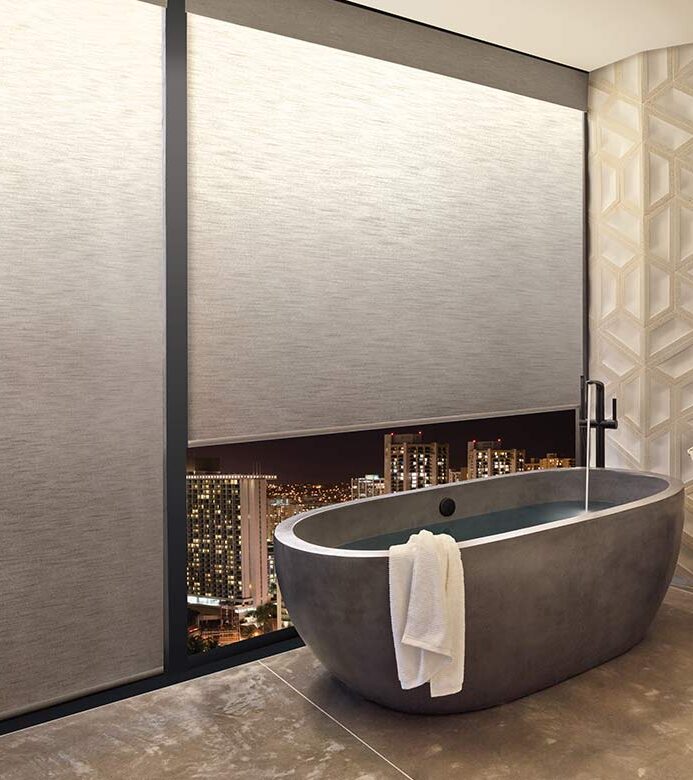 bathroom with illuminated roller shades at night with bathtub in nova scotia