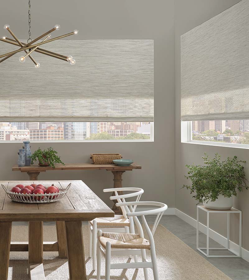 neutral woven window shades with automation in dining room