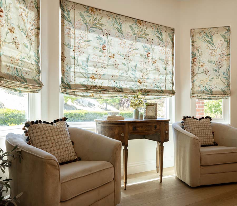 living room with floral fabric roman shades seeview