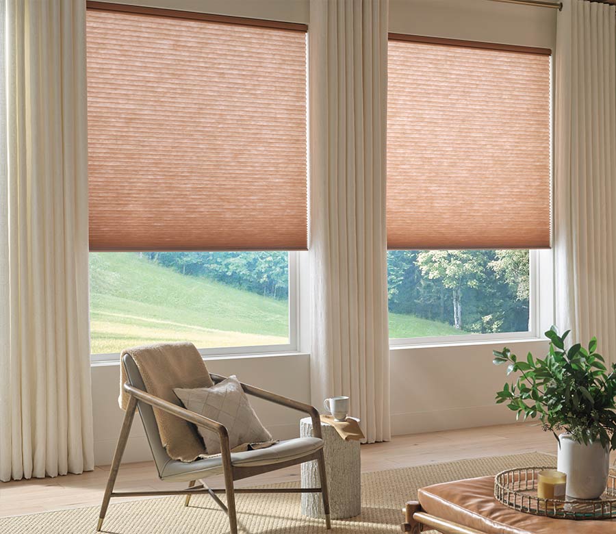 pink cellular shades in living room paired with white drapery