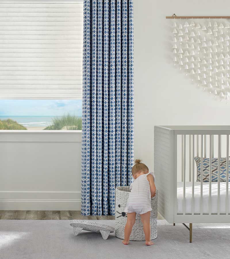 child-safe-sonnette-literise-hunter-douglas-cordless-window-shades-gotcha-covered-seeview-nova-scotia blue patterned window drapery paired with white window coverings nova scotia