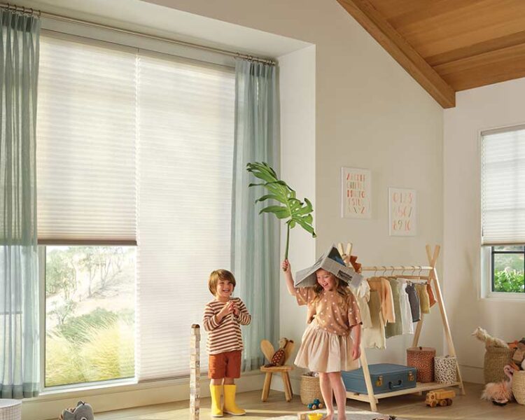 blue sheer drapery paired wiht white honeycomb window shades in childrens playroom