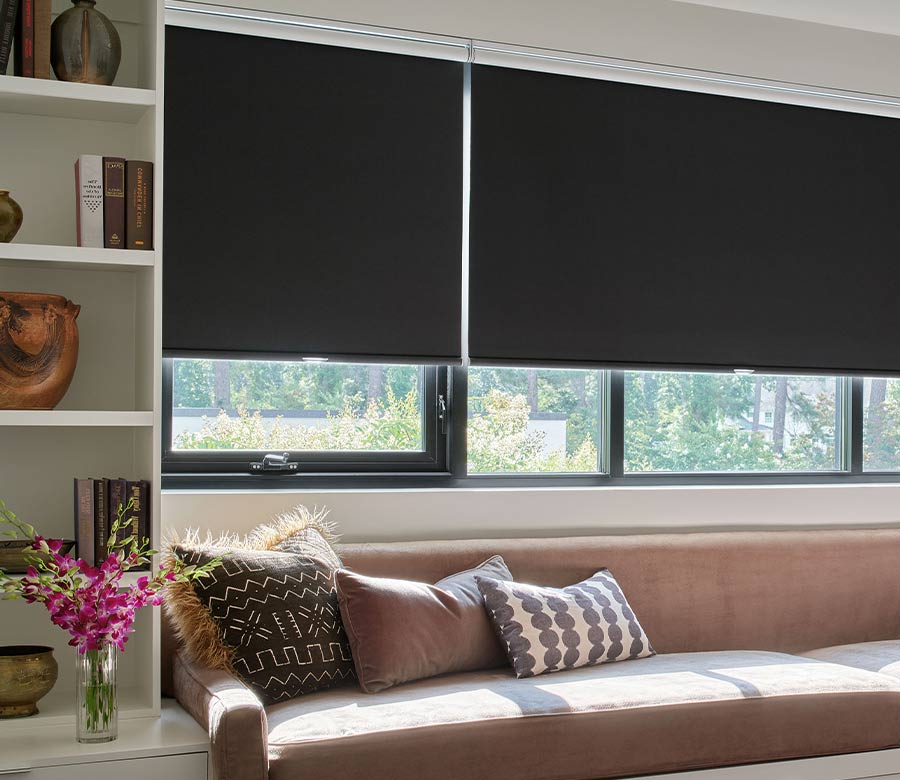 black roller window shade over couch in office