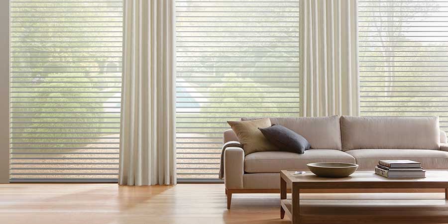 drapery paired with shades behind couch all neutral vibe