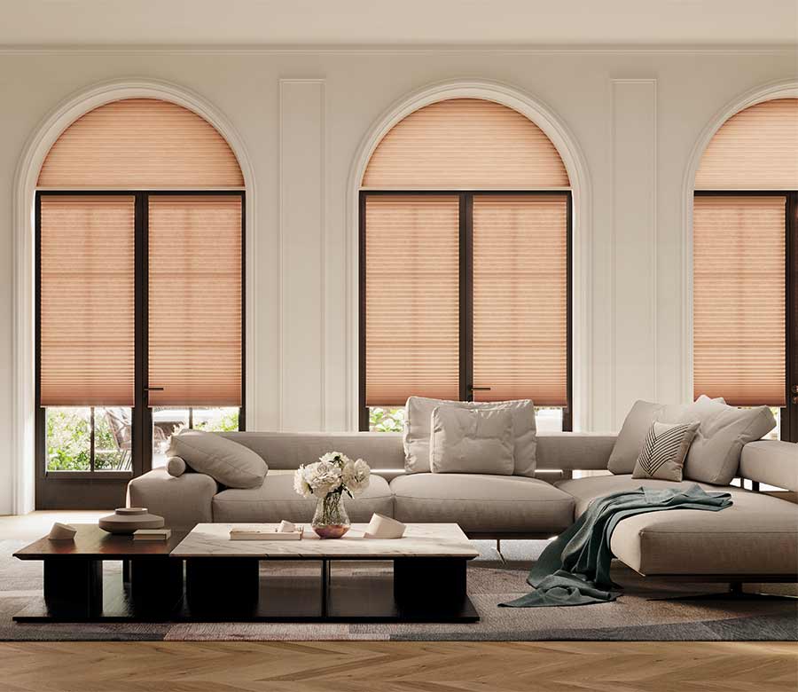 peach colored cellular shades with arches in living room