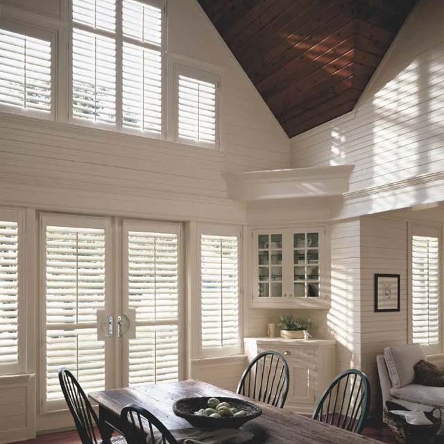 environmentally-friendly window shutters on french doors and large windows in living room seeview