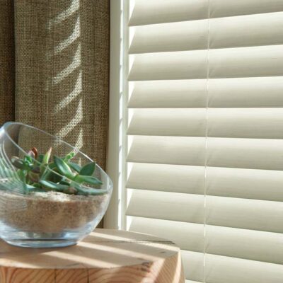 everwood white window blinds detail next to table with decorative succulent