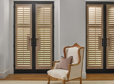 real wood shutters with black trim on large french doors traditional style