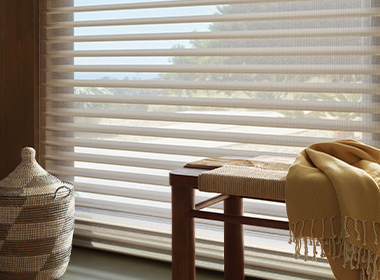 white sheer shades with bench and yellow blanket