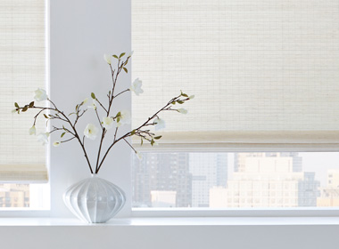 white woven shades with white vase