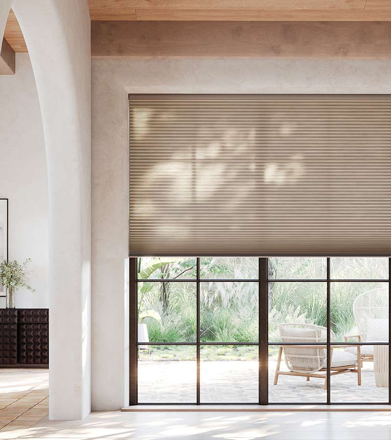 brown cellular window shades floor to ceiling on black framed windows