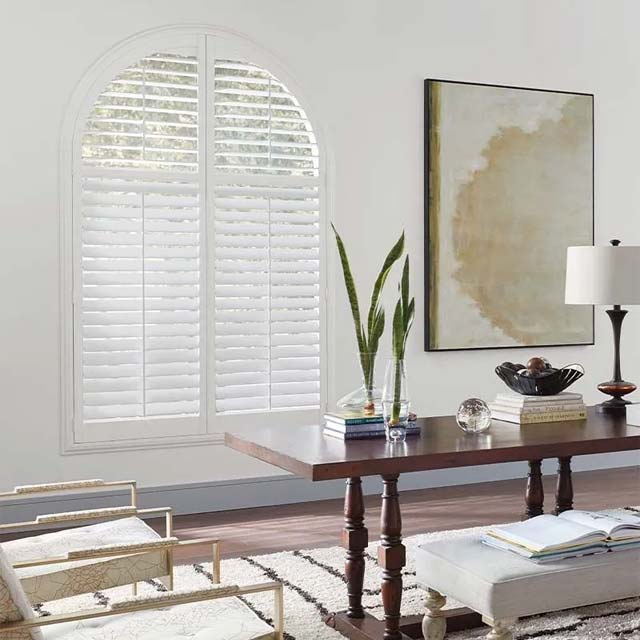 modern-design white wood shutters with angled windows in home office