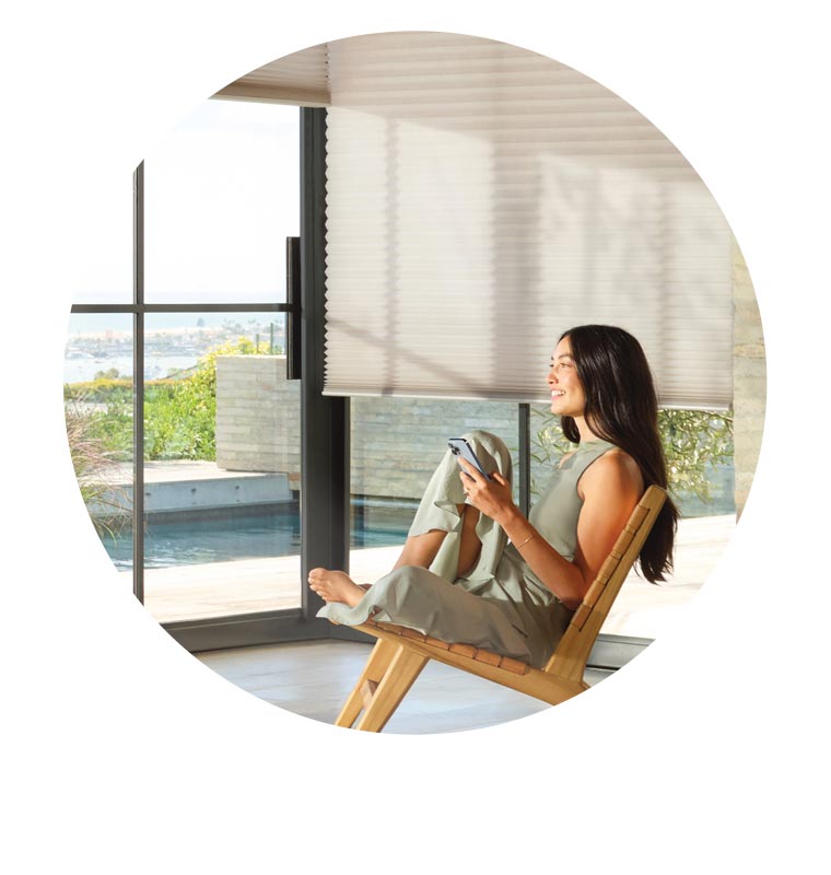 powerview-automation-voice-control-duette-honeycomb-shades-hunter-douglas person using an app for automatic blinds