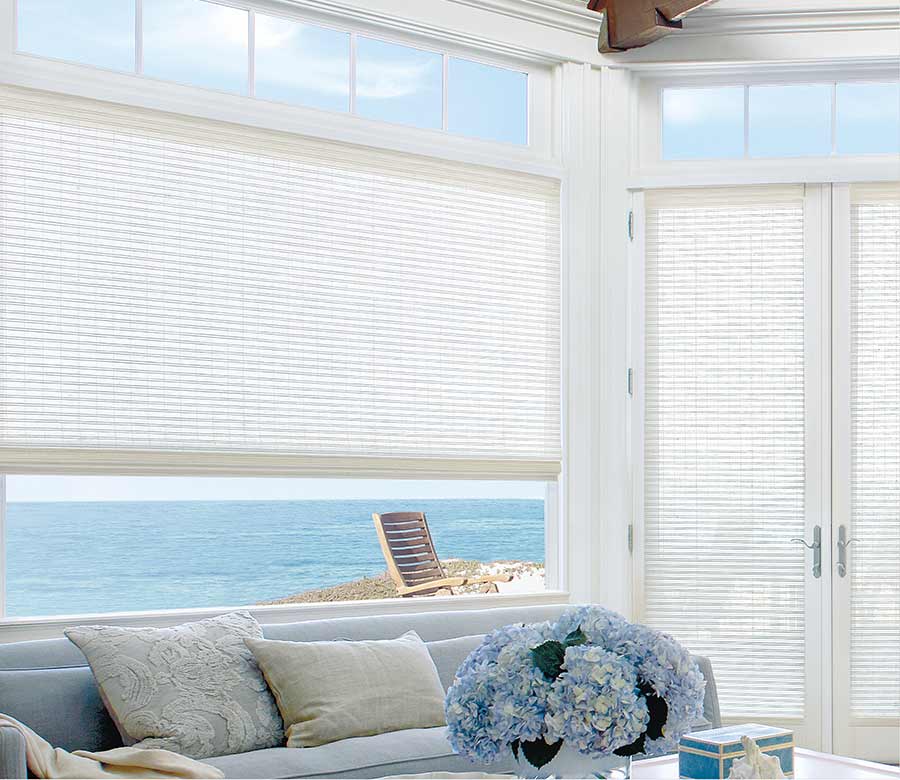 white woven wood shades in porch area and also on glass doors