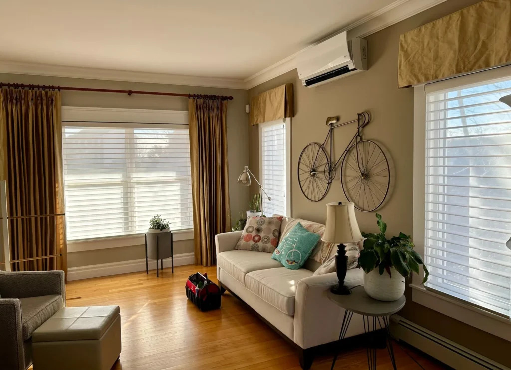 sheer shades in living room paired with yellow drapery
