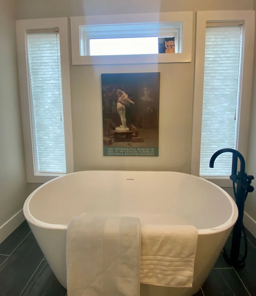 narrow white honeycomb window shades in bathroom