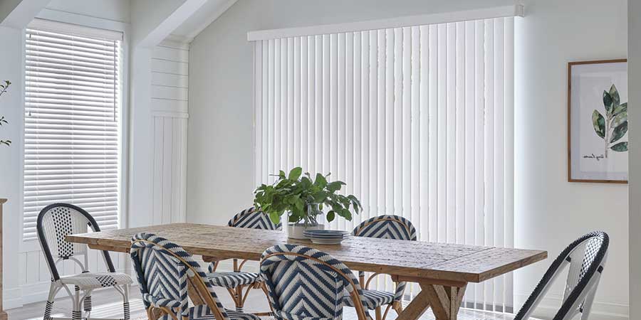 dining room with vertical blinds on glass door