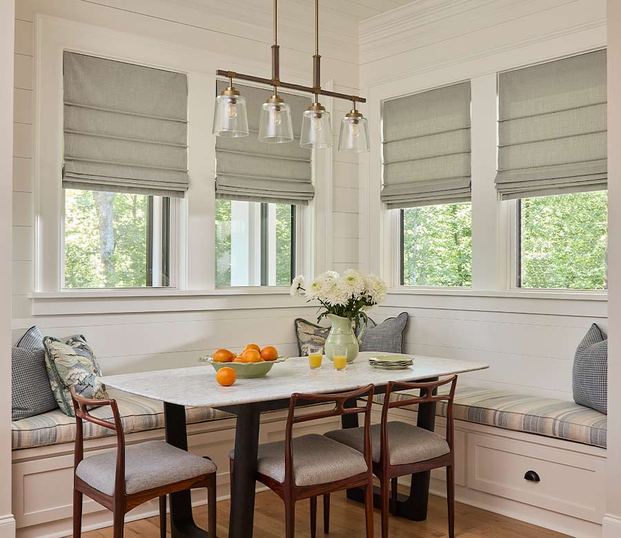 breakfast nook with green woven roman shades