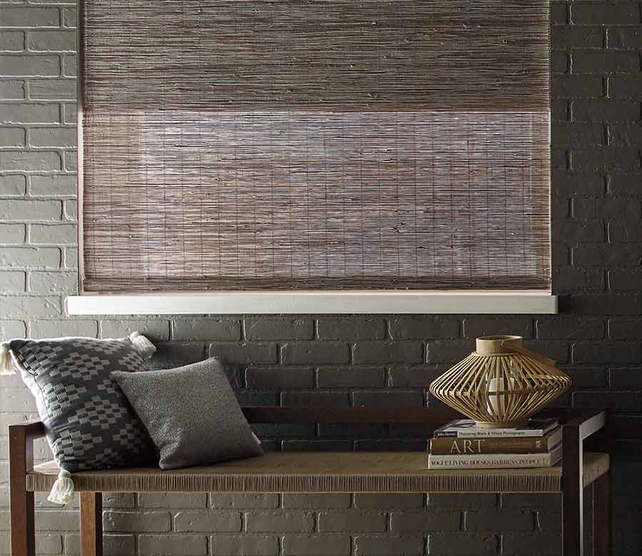 dark colored woven roman shades with dual shades in hallway