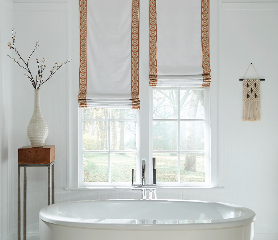 custom roman shades in bathroom with tub