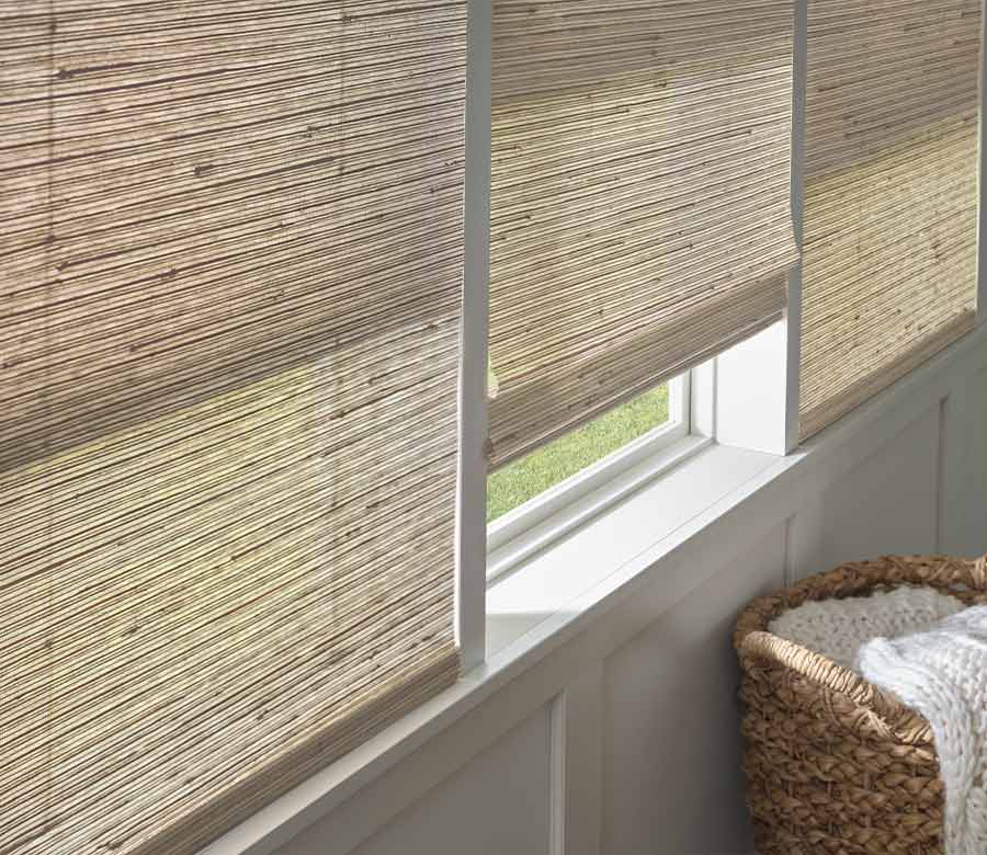 light colored woven window shades in bedroom