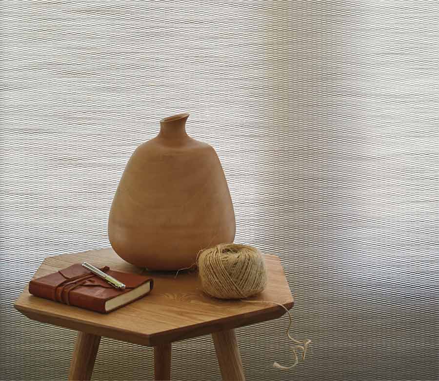 textured window shades with decorative vase and twine