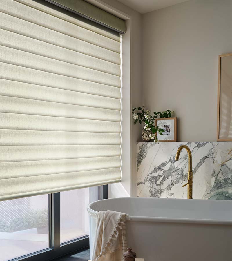 bathroom with white pirouette shades and white soaking tub