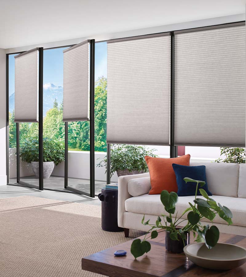 tilt-and-turn-living-room-european-window-treatments-gotcha-covered-seeview-nova-scotia living room with white tilt and turn honeycomb window shades with black window trim