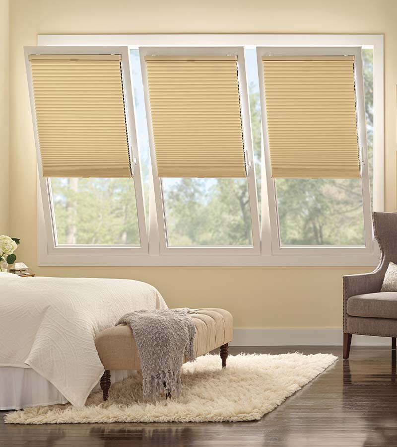 tilt-and-turn-primary-bedroom-european-window-treatments-gotcha-covered-seeview-nova-scotia bedroom with cream tilt and turn honeycomb window shades