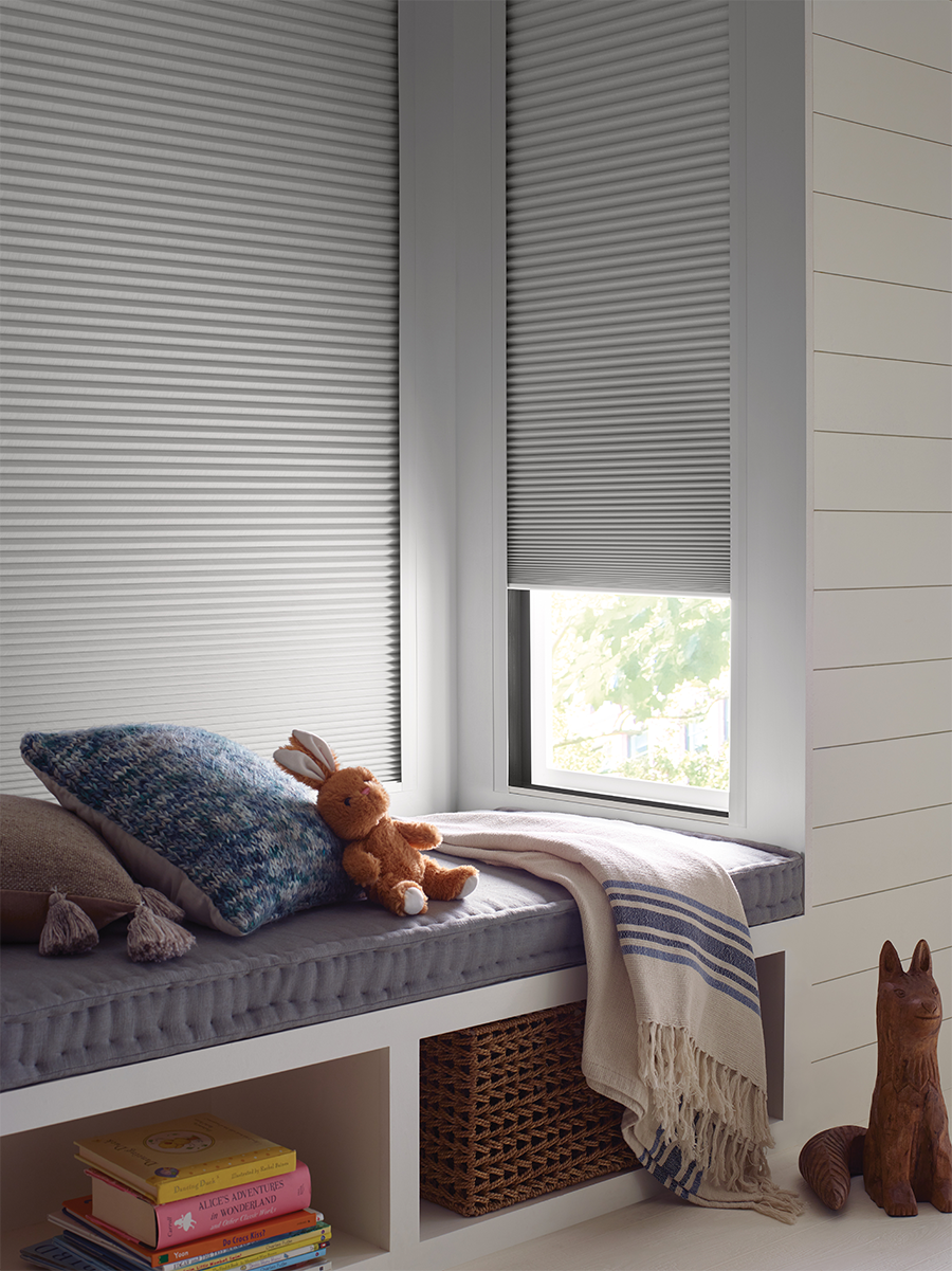 Duette LightLock system blocking light gaps around blackout honeycomb shades