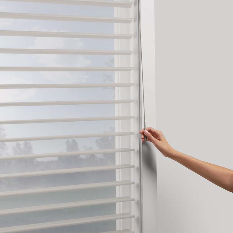 SoftTouch™ Motorization adjusts shades with a gentle push or pull of the wand